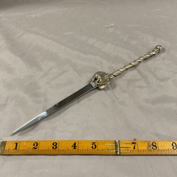 Antique silver letter opener with a frog and lily pad design.