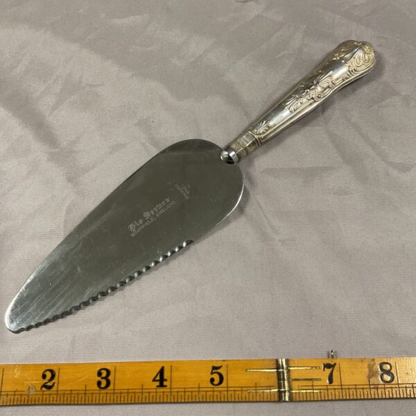 Vintage silver plated cake server with ornate handle.