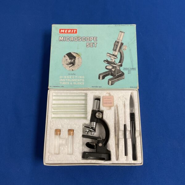 Vintage Merit microscope set in original box, collectible science toy.