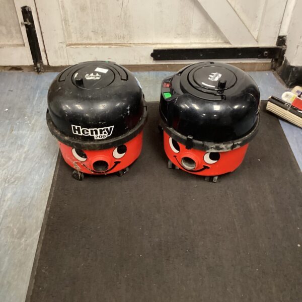 Two red Numatic Henry vacuum cleaners for spares or repair.