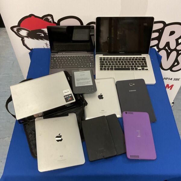 Mixed lot of used tablets and laptops including Apple devices.