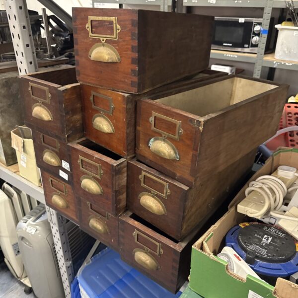 Stack of vintage wooden drawers for storage and display.