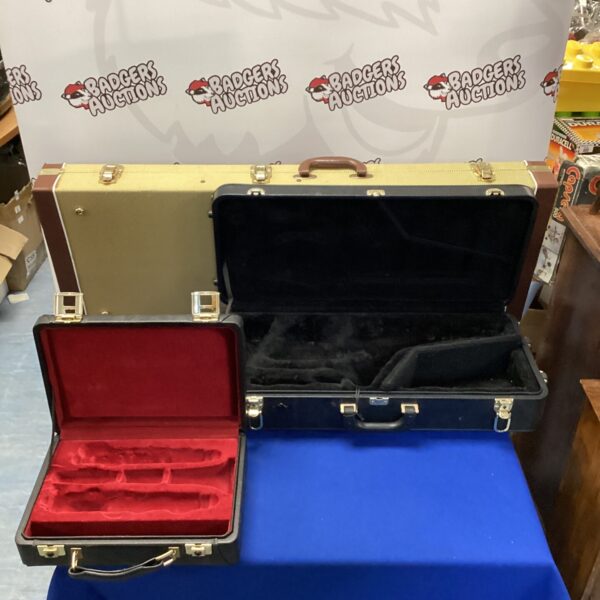 Burgundy vintage instrument case set with guitar, saxophone, and flute.