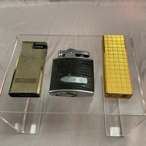 Gold vintage Ronson lighter with textured surface.