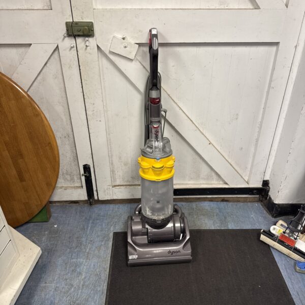 Dyson DC14 upright vacuum cleaner in a home setting.