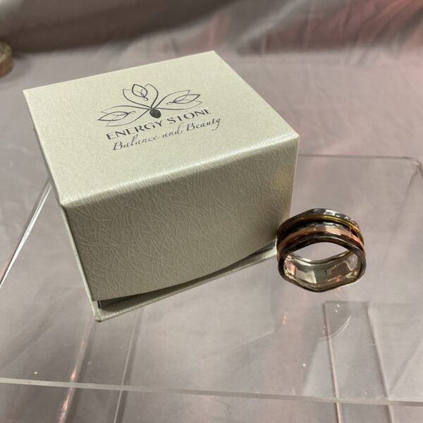 Silver spinner ring by Energy Stone with copper brass details.