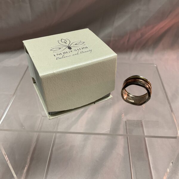 Silver spinner ring with copper and brass details, size U.