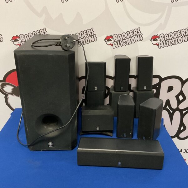 Black Yamaha surround sound system with multiple speakers and subwoofer.