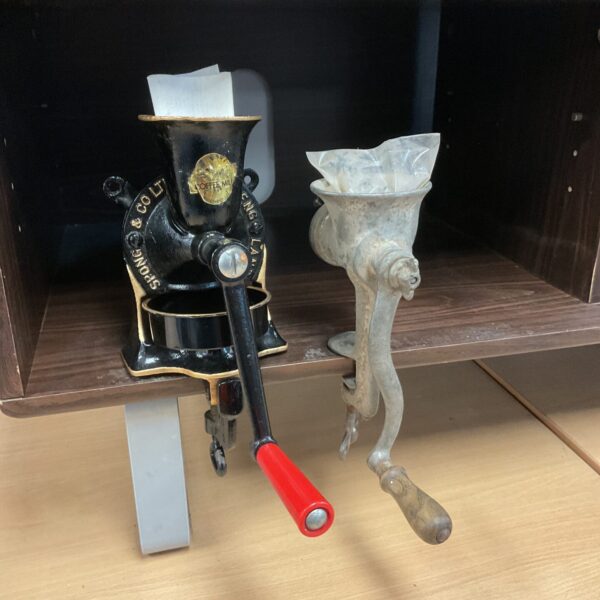 Vintage Spong coffee mill with red handle and cast iron body.