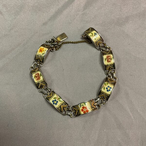 Vintage whitemetal bracelet with colourful enamel flower panels.