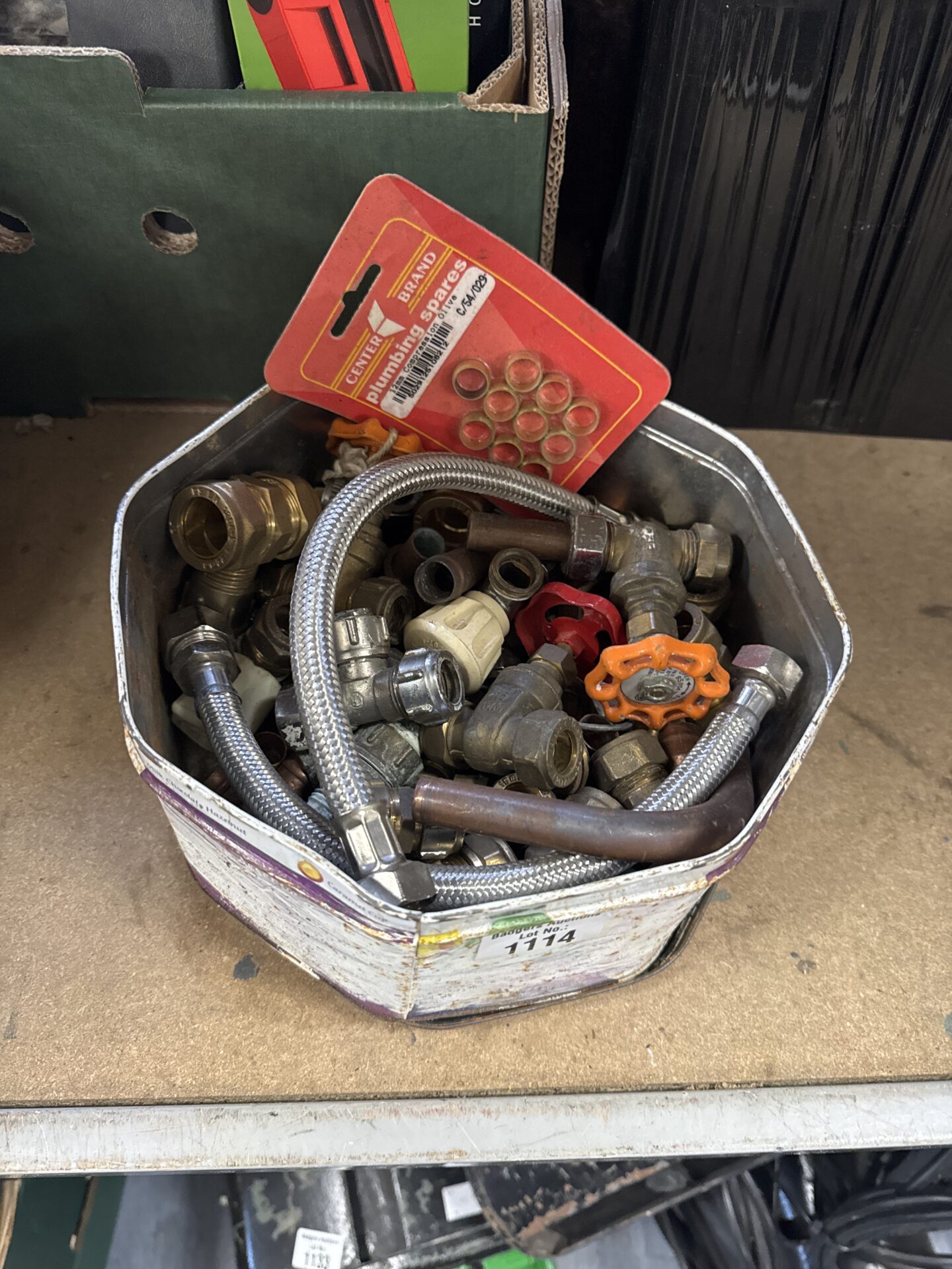1114 Quality street tin of assorted plumbing fittings