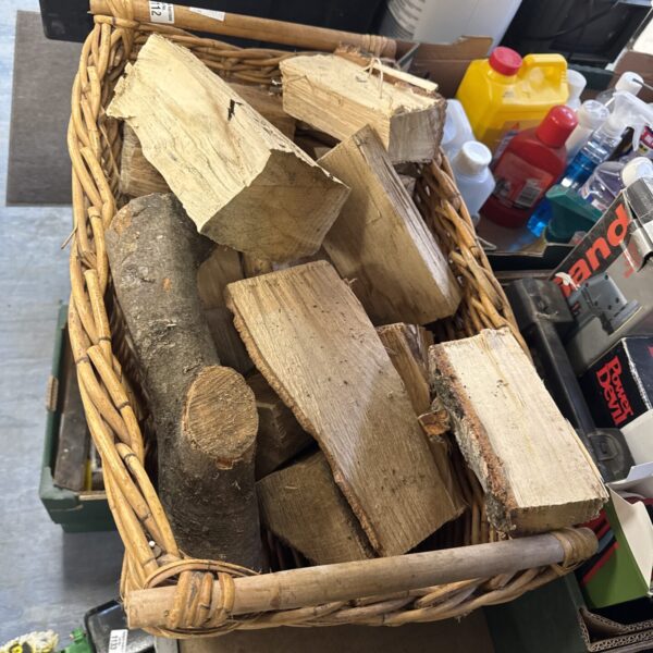 Wicker log basket filled with firewood for rustic home decor.