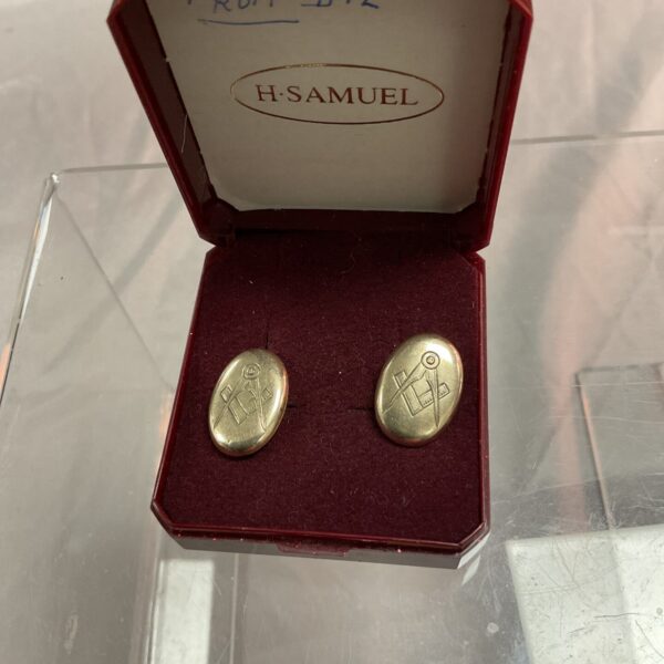 Vintage Masonic cufflinks with square and compasses symbol.