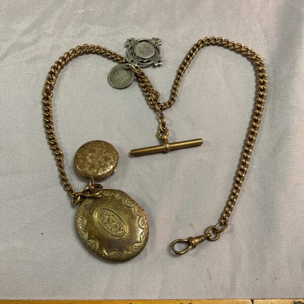 Antique Victorian Albert chain with silver fobs, a classic accessory.
