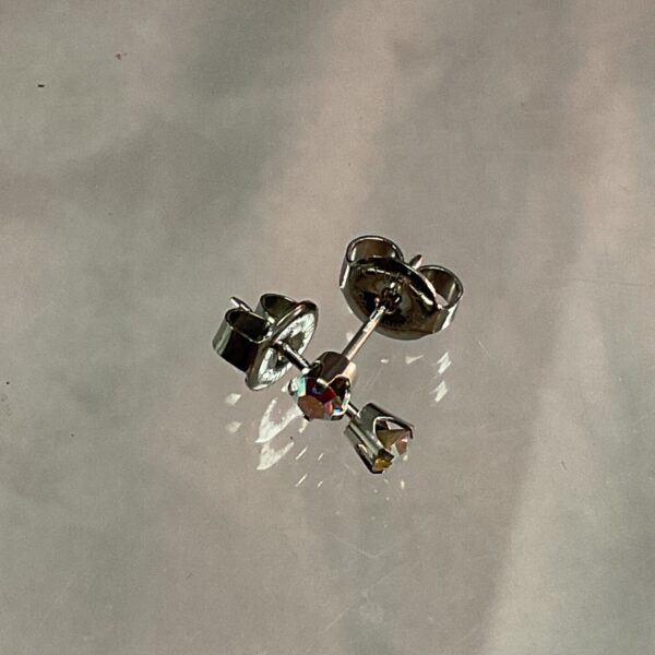 Close-up of 9ct white gold coloured stone stud earrings.