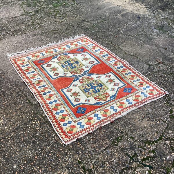 Vibrant Aztec style rug with geometric patterns.