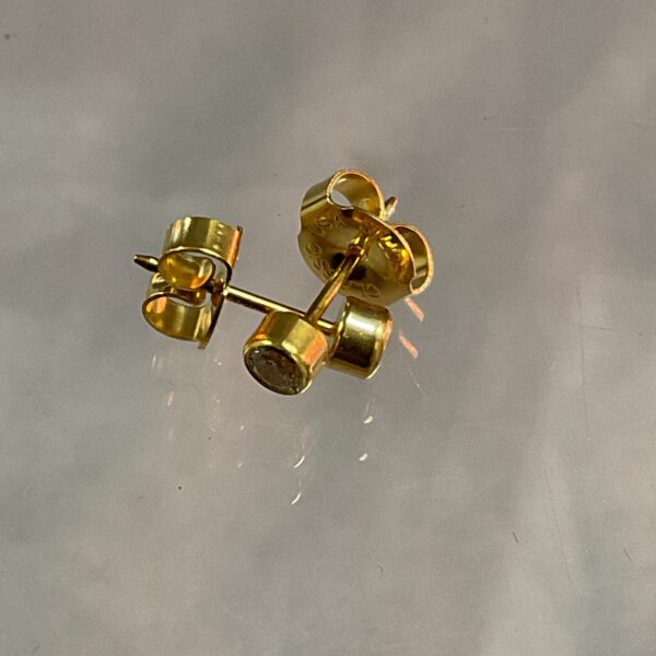 Close-up of 9ct gold white stone stud earrings.