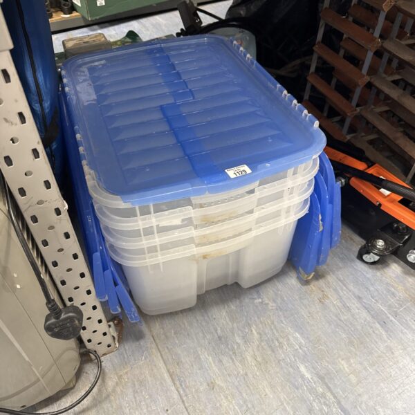 Clear plastic storage boxes stacked for home organisation.