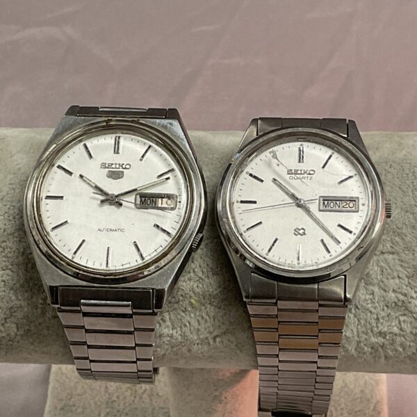 Vintage Seiko wristwatches pair, stainless steel bracelets, collectible timepieces.