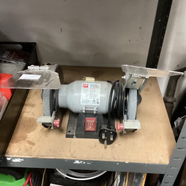 Performance bench grinder, a used workshop tool for metalworking.
