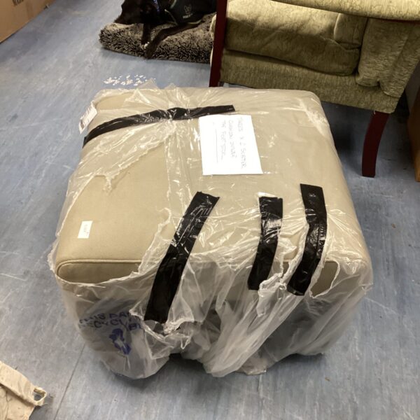 Large upholstered footstool with two scatter cushions inside.