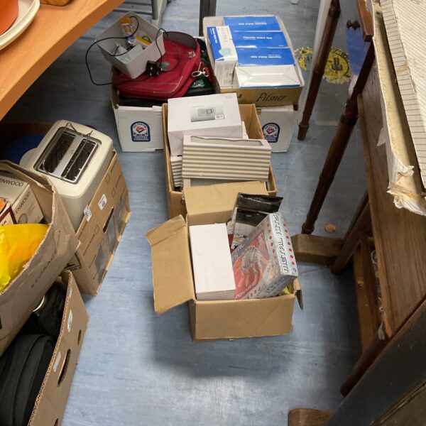 Mixed lot of boxes containing disposable masks and household items.