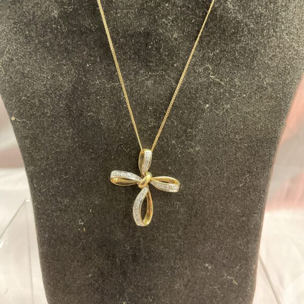 Elegant 9ct gold diamond pendant necklace on a chain.