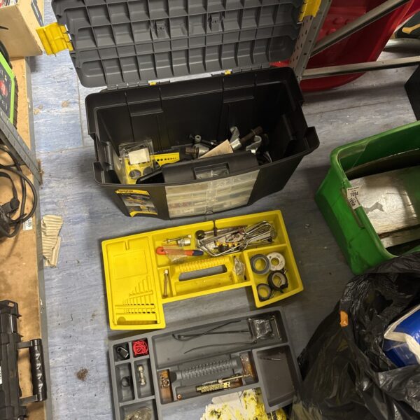 Filled Stanley toolbox with tools and hardware for workshop storage.