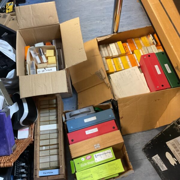 Large collection of 35mm slides in storage boxes, vintage photography archive.