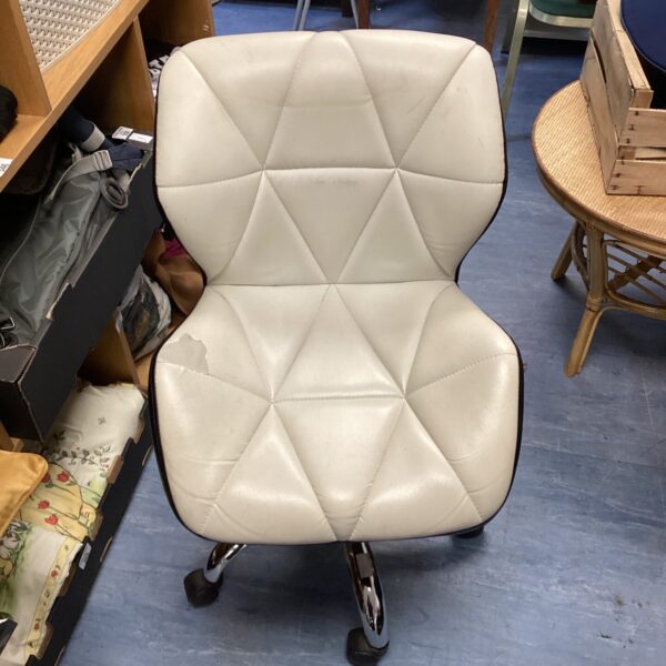 White leather swivel chair with chrome base, mid-century modern style.