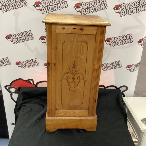 Vintage oak side cupboard with a single door for storage.