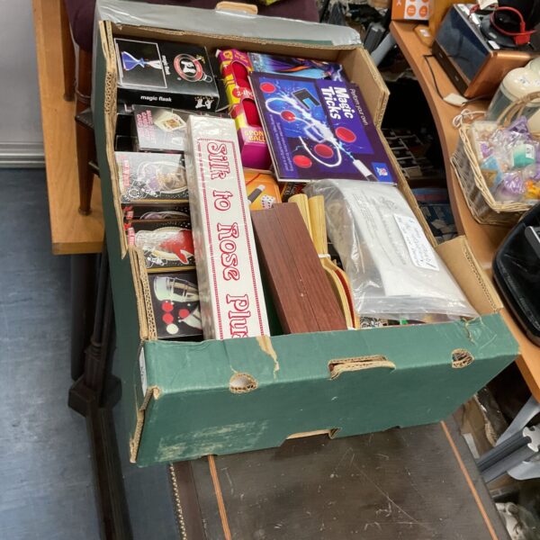 Box of mixed vintage and new magic toys for collectors.