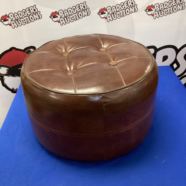 Brown leather pouffe, a vintage ottoman for comfortable seating.