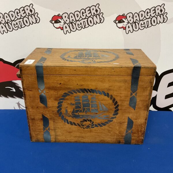Vintage wooden storage box with nautical ship and anchor design.