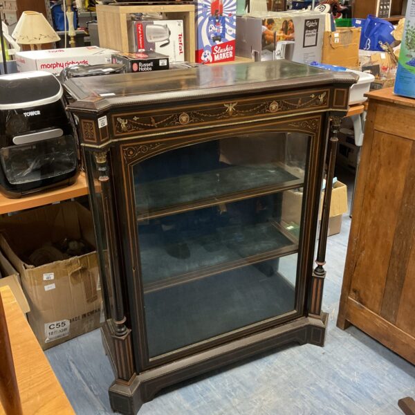 Antique Victorian display cabinet with inlaid design and glazed door.