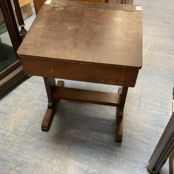 Front view of a vintage wooden school desk.