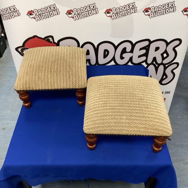 Pair of vintage upholstered footstools with wooden legs.