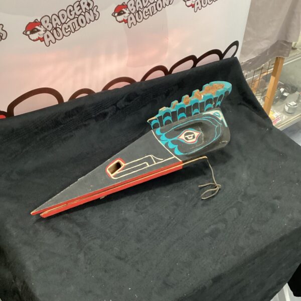 Front view of a vibrant handmade bird mask.