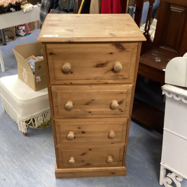 Vintage pine four-drawer chest for bedroom storage.