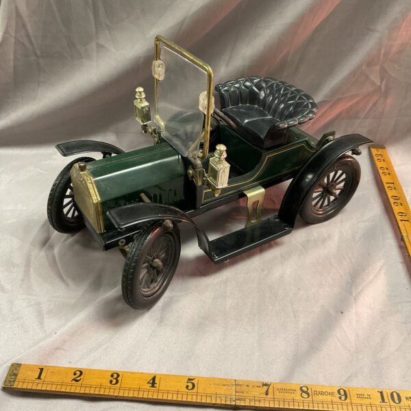 Vintage Harrods Model T Ford tinplate toy car side view.