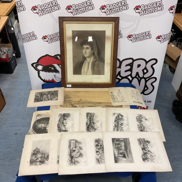 Collection of vintage portrait prints on a table.