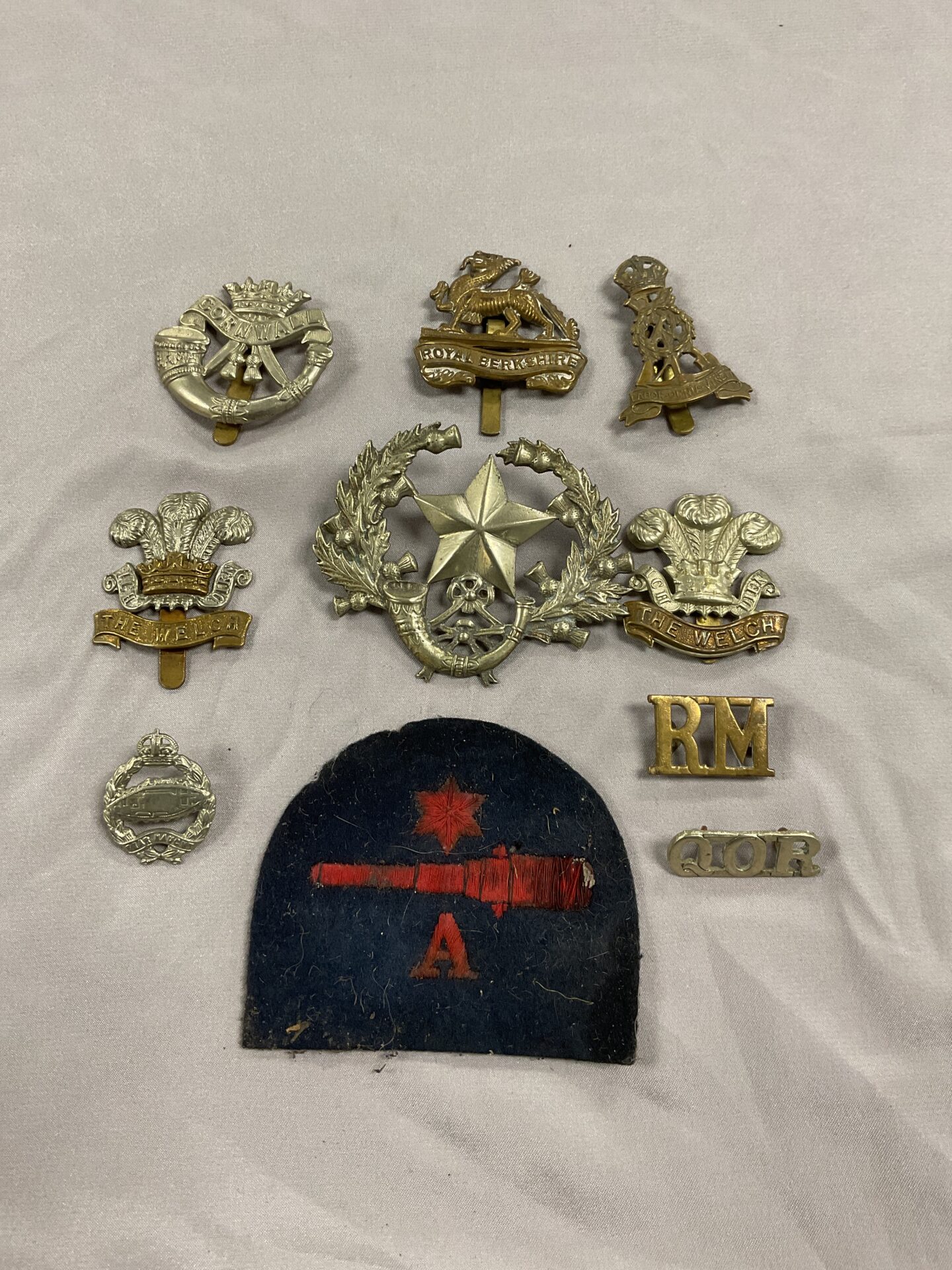 807 Collection of military cap badges and navy gunners patch