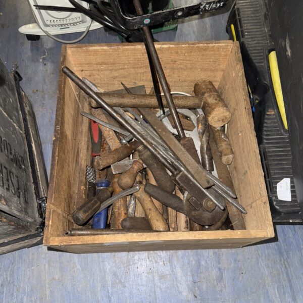 Assorted vintage hand tools in a metal box.
