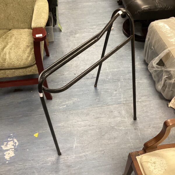 Vintage metal riding saddle rest for equestrian use.