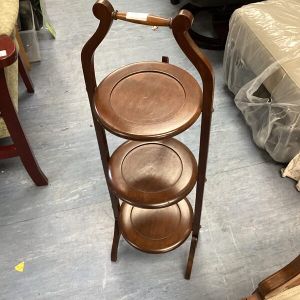 Vintage wooden three-tier cake stand for serving and display.
