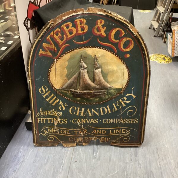Antique Webb & Co ships chandlers sign with sailing ship illustration.