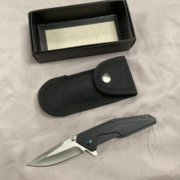 Black ribbed handle D2 pocket knife with nylon sheath.