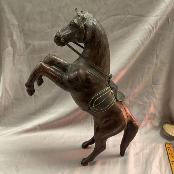 Vintage leather rearing horse sculpture in dynamic pose.