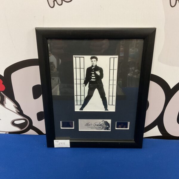 Framed Elvis Presley filmcell display, authentic movie prop collectible.