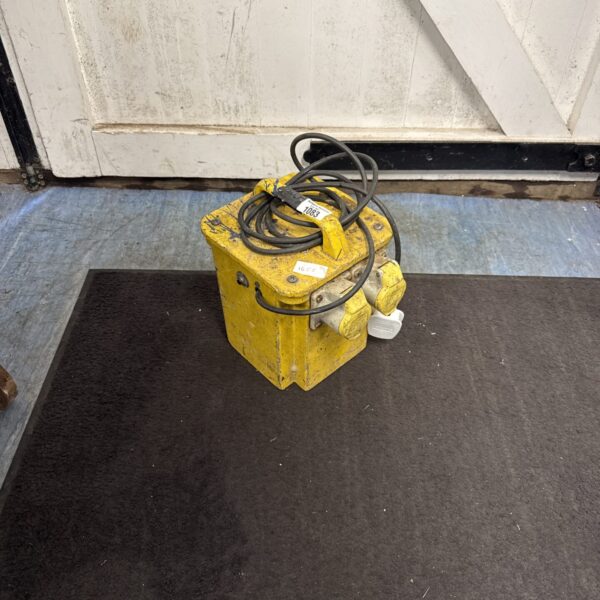 Yellow 110v transformer block with wired connections.